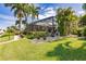 Landscaped backyard with screened pool enclosure and lush greenery at 1200 Via Tripoli, Punta Gorda, FL 33950