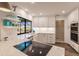Modern kitchen with white cabinets, stainless steel appliances and breakfast bar at 1200 Via Tripoli, Punta Gorda, FL 33950