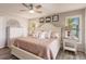 Main bedroom with a king-size bed, dresser, and ceiling fan at 1200 Via Tripoli, Punta Gorda, FL 33950