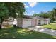 House exterior featuring a two-car garage and lawn at 2299 Hamlin Ct, Valrico, FL 33594