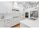 Modern kitchen with white cabinets, stainless steel appliances and expansive countertops at 4013 Red Rock Ln, Sarasota, FL 34231