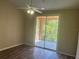 Bright bedroom with wood-look floors and access to a private balcony at 4102 Central Sarasota Pkwy # 922, Sarasota, FL 34238