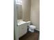 Clean bathroom with white vanity, toilet and dark brown laminate flooring at 4102 Central Sarasota Pkwy # 922, Sarasota, FL 34238