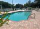 Inviting community pool with lounge chairs and brick deck at 4102 Central Sarasota Pkwy # 922, Sarasota, FL 34238