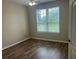 Spacious bedroom with large window and wood-look floors at 4102 Central Sarasota Pkwy # 922, Sarasota, FL 34238