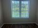 Bright bedroom with large window and dark brown laminate flooring at 4102 Central Sarasota Pkwy # 922, Sarasota, FL 34238