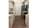 Modern kitchen with stainless steel appliances and wood-look floors at 4102 Central Sarasota Pkwy # 922, Sarasota, FL 34238