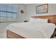 Well-lit bedroom with king-size bed and window coverings at 17724 Gawthrop Dr # 201, Bradenton, FL 34211