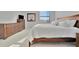 Bright bedroom featuring a king bed, dresser, and large window at 17724 Gawthrop Dr # 201, Bradenton, FL 34211