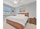 King-size bed, nightstand, and ceiling fan in this sunny bedroom at 17724 Gawthrop Dr # 201, Bradenton, FL 34211