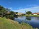 Serene lake view with lush landscaping and beautiful reflections at 4210 66Th Street W Cir, Bradenton, FL 34209