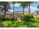 Landscaped backyard with lush greenery, mature trees, and home view at 7676 Bergamo Ave, Sarasota, FL 34238