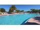 Resort-style pool with plenty of lounge chairs and umbrellas at 7676 Bergamo Ave, Sarasota, FL 34238