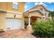 Townhouse exterior showcasing a white garage door and covered entryway at 7676 Bergamo Ave, Sarasota, FL 34238