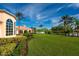 Expansive green lawn with clubhouse view at 7676 Bergamo Ave, Sarasota, FL 34238