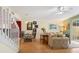 Living room with hardwood floors, beige sofa, and access to a patio at 7676 Bergamo Ave, Sarasota, FL 34238