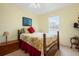 Bedroom with a full-size bed and a wooden dresser at 7676 Bergamo Ave, Sarasota, FL 34238