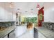 Modern kitchen with stainless steel appliances and granite countertops at 7676 Bergamo Ave, Sarasota, FL 34238