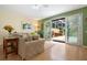 Living area with hardwood floors, sliding doors to a patio, and a view of the backyard at 7676 Bergamo Ave, Sarasota, FL 34238