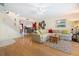 Living room with hardwood floors, beige sectional sofa, and kitchen view at 7676 Bergamo Ave, Sarasota, FL 34238