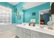 Bathroom with double vanity, large mirror, and bathtub at 7676 Bergamo Ave, Sarasota, FL 34238