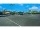 Well-maintained tennis courts with covered seating areas at 7676 Bergamo Ave, Sarasota, FL 34238