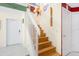 Staircase with hardwood steps and white railings at 7676 Bergamo Ave, Sarasota, FL 34238