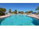 Resort-style pool with plenty of lounge chairs and umbrellas at 7676 Bergamo Ave, Sarasota, FL 34238
