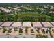 Aerial view of a row of townhouses with lush landscaping and waterway at 7676 Bergamo Ave, Sarasota, FL 34238