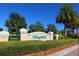 Community entrance with signage, landscaping, and brick-paved road at 7676 Bergamo Ave, Sarasota, FL 34238