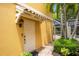 Side view of townhouse with white door and neatly landscaped walkway at 7676 Bergamo Ave, Sarasota, FL 34238