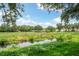 Tranquil waterfront view with lush greenery and homes in the background at 7676 Bergamo Ave, Sarasota, FL 34238