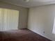 Bedroom with carpet, neutral walls, and sliding door access at 4210 66Th Street W Cir, Bradenton, FL 34209