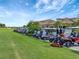 Golf carts parked near clubhouse on sunny day at 17724 Gawthrop Dr # 201, Bradenton, FL 34211