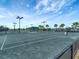Well-lit tennis courts with fencing and seating at 17724 Gawthrop Dr # 201, Bradenton, FL 34211