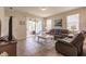 Living room with leather couches, a coffee table and access to a patio at 8269 Enclave Way # 103, Sarasota, FL 34243
