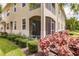 Exterior view of the property showcasing a screened patio and landscaping at 8269 Enclave Way # 103, Sarasota, FL 34243