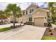 Three-story townhome with two-car garage, landscaping, and palm trees in front at 8269 Enclave Way # 103, Sarasota, FL 34243