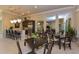 Community room with tables, chairs, and a kitchen at 8269 Enclave Way # 103, Sarasota, FL 34243