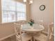 White round table with four chairs in a cozy dining area at 8269 Enclave Way # 103, Sarasota, FL 34243