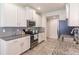 Modern kitchen with white cabinets, granite counters, and stainless steel appliances at 8269 Enclave Way # 103, Sarasota, FL 34243