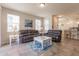 Spacious living room with leather sofas and a large TV at 8269 Enclave Way # 103, Sarasota, FL 34243
