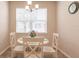 Bright dining area with white table and chairs at 8269 Enclave Way # 103, Sarasota, FL 34243
