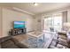 Relaxing living room with leather sofas and patio access at 8269 Enclave Way # 103, Sarasota, FL 34243