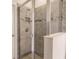 Clean shower with neutral tile and glass enclosure at 8269 Enclave Way # 103, Sarasota, FL 34243