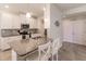 Modern kitchen with white cabinets, granite counters, and stainless steel appliances at 8269 Enclave Way # 103, Sarasota, FL 34243