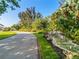 Paved walkway with lush tropical landscaping and a small waterfall at 24 Tidy Island Blvd # 24, Bradenton, FL 34210