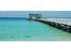 Wooden pier extending over crystal-clear turquoise water at 24 Tidy Island Blvd # 24, Bradenton, FL 34210