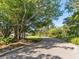 Landscaped entryway with a large tree and paved path at 24 Tidy Island Blvd # 24, Bradenton, FL 34210