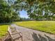 Peaceful walking path with bench under shade trees at 24 Tidy Island Blvd # 24, Bradenton, FL 34210